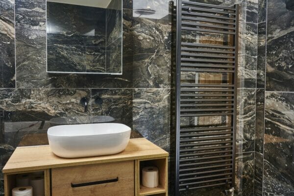 Terzetto Stone Orobico Dark porcelain used on bathroom walls, in front of bathtubs.